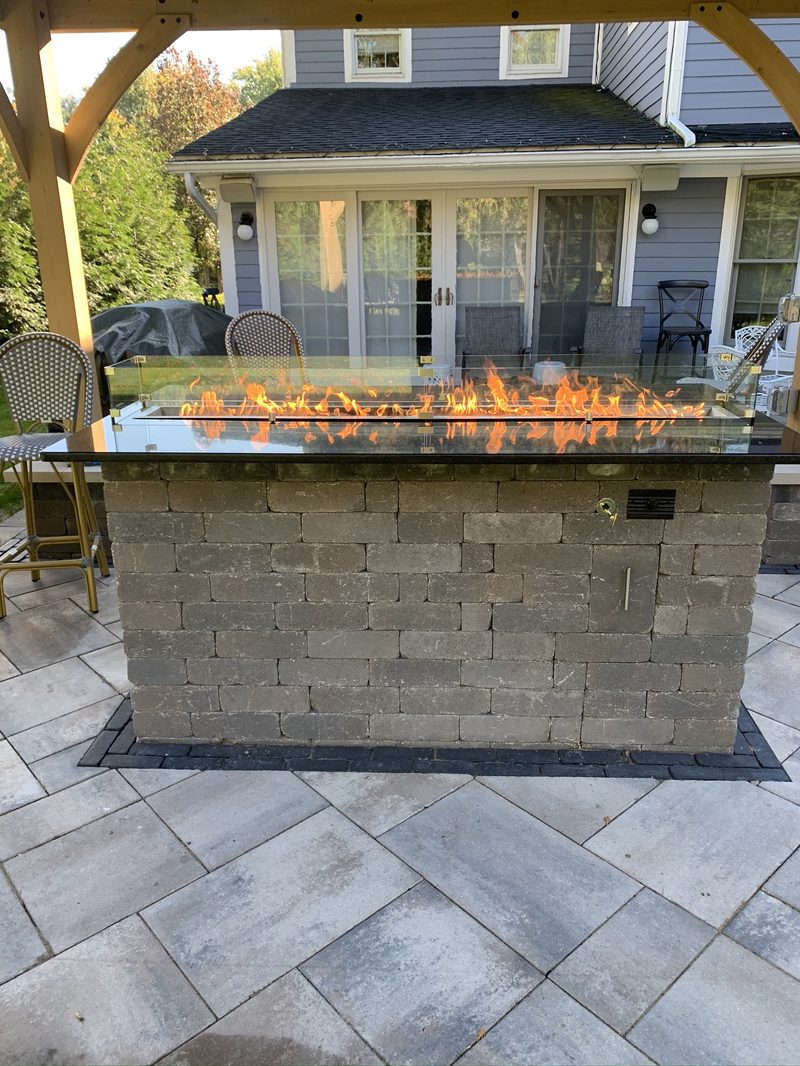 Linear gas fire table under pergola