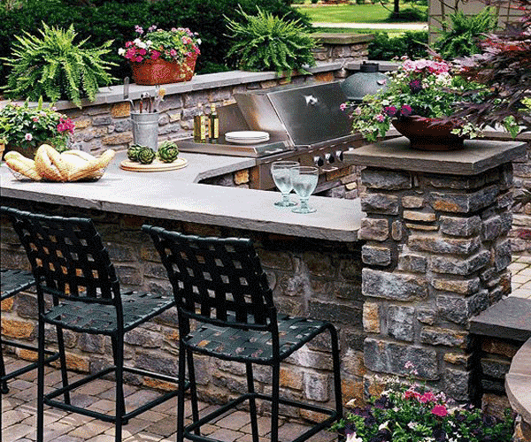 Outdoor living space with seating and stone fireplace