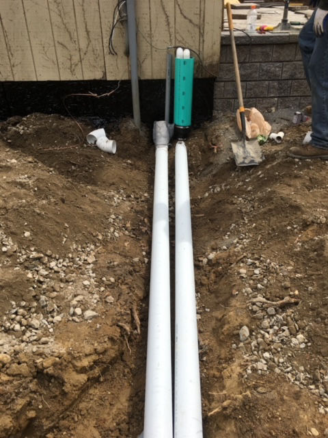 running pipes away from foundation for water drainage