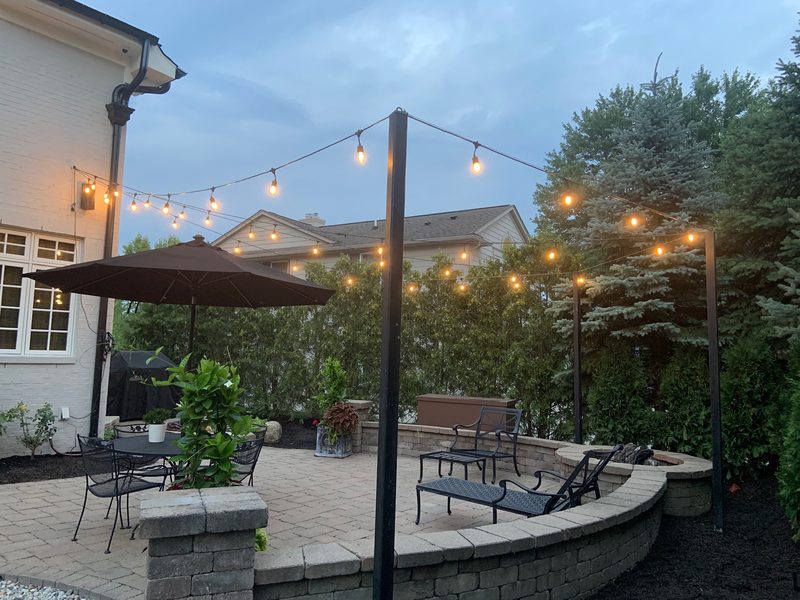 String lights over patio at dusk